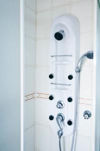 a shower with a shower head in a bathroom at Alentejo Pig dog surf camp in Palhota