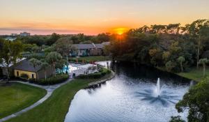 an aerial view of a lake with a fountain at Landing Fort Myers - Forestwood in Fort Myers