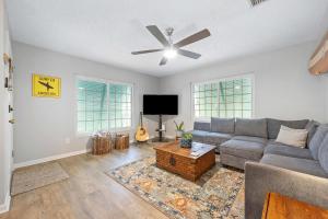 a living room with a couch and a tv at Casa Playa - Private Home for 6 in St. Augustine