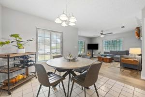a living room with a table and chairs and a couch at Casa Playa - Private Home for 6 in St. Augustine