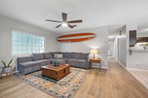 a living room with a couch and a ceiling fan at Casa Playa - Private Home for 6 in St. Augustine