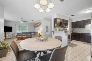a kitchen and a living room with a table and chairs at Casa Playa - Private Home for 6 in St. Augustine +26 photos
