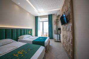 Postel nebo postele na pokoji v ubytování Hotel Royal