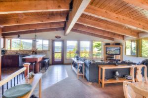 a large living room with wooden ceilings and windows at Chamberland Getaway Lake Views with Deck in Tahoma +25 photos