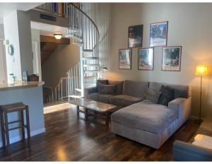 a living room with a couch and a stair case at Lake Forest Villa Patio w BBQ in Tahoe City