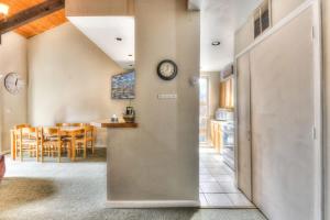 a kitchen and dining room with a clock on the wall at Lake Forest Villa Patio w BBQ in Tahoe City +19 photos
