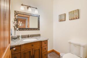 a bathroom with a sink and a mirror at Sunny Woods Acres - Near Golf & Adventure Park in Tahoe Vista