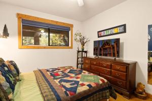 a bedroom with a bed and a dresser and a window at Sierra Pines Retreat - Sleeps 6 in Incline Village