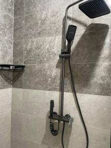 a shower with a blow dryer in a bathroom at Guest house Amirhan in Bokonbayevo +41 photos
