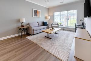 a living room with a couch and a table at Landing Bellingham Park - Wilmington in Wilmington