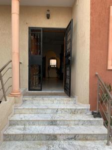 an open door of a house with stairs leading to it at Great Villa in Hammam Sousse in Hammam Sousse
