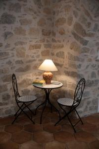a table with two chairs and a lamp on it at La Magnolia in Centola