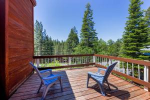 two chairs sitting on a wooden deck with trees at Kitzbuhel Paradise Sleeps 8 in Truckee