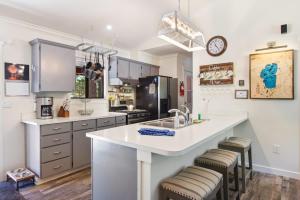 a kitchen with a large white counter and stools at Incline Bliss Dreamy Pet Friendly Escape in Incline Village