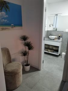 a bathroom with a chair and a sink at Villa Adriatique in Maslenica