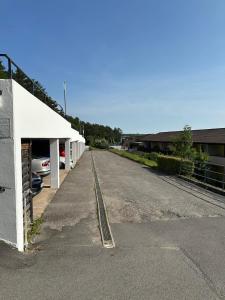 an empty parking lot next to a white building at Apartment Panoramablick in Bad Mergentheim