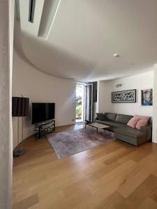 a living room with a couch and a flat screen tv at Dukley Retreat, Serenity Collection in Budva