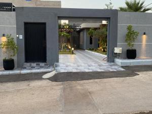 a front entrance to a building with a door at شاليه فيلا ـ Sw ـ بحديقة خارجية in Buraydah