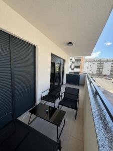 a balcony with chairs and a table on a building at Apartman Andrea in Trebinje