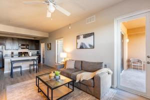 a living room with a couch and a table at Landing Fort Myers near Heritage Palms in Fort Myers