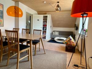 a dining room with a table and chairs and a couch at Silkeby Bed & Breakfast in Silkeborg