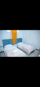 a bedroom with two beds and a window at Villa 59 in Shkodër