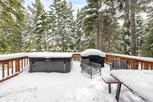 a deck covered in snow with tables and chairs at Tahoe City Retreat - For 8 in Tahoe City