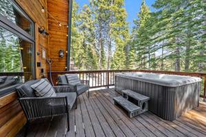 a deck with a hot tub and chairs at Tahoe City Retreat - For 8 in Tahoe City
