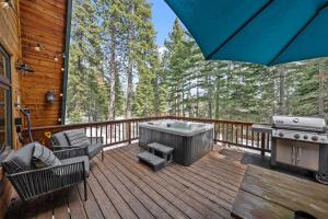 a porch with a hot tub and a grill on a deck at Tahoe City Retreat - For 8 in Tahoe City
