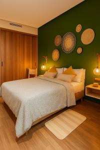 a bedroom with a large bed with a green wall at Appartement Cosy et chaleureux - Casablanca centre in Casablanca