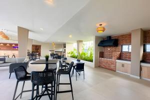 a restaurant with tables and chairs and a brick wall at Epic Punta Cana in Punta Cana