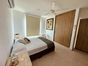a bedroom with a bed and a sliding door at Puerto Azul in Puerto Colombia