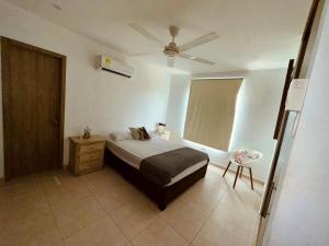 a bedroom with a bed and a ceiling fan at Puerto Azul in Puerto Colombia +11 photos