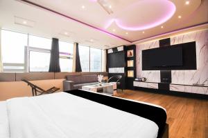 ダンバードにあるHotel O Hirak Road Dhanbadのベッドと薄型テレビがあるホテルの部屋