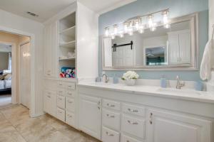 a white bathroom with two sinks and a mirror at Waterfront Lake Bridgeport Home with Private Dock in Bridgeport +23 photos