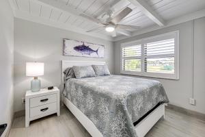 a bedroom with a bed and a ceiling fan at Steps to Englewood Beach Home with Outdoor Oasis! in Englewood