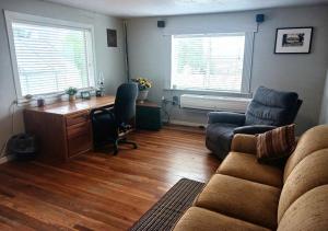 a living room with a couch and a desk at WELCOME TO VIGILANTE INN "Earp" in Tombstone +7 photos