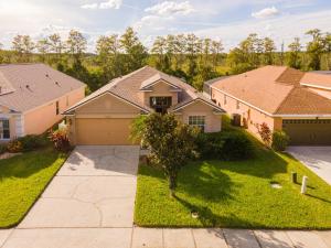 a house in a subdivision with a driveway at Sunset Dreams Villa, Beautiful 4 Bedroom Villa with Private Pool Near Disney 422 in Orlando