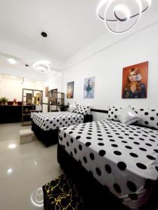 two beds in a room with black and white sheets at Kingston Manor Vacation Homes in Kingston