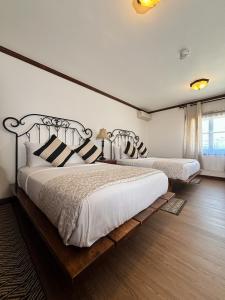 a bedroom with two beds and a window at Hacienda San Angel in Ensenada +66 photos
