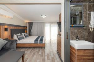 a bedroom with a bed and a bathroom with a sink at La Serena Taksim in Istanbul +51 photos