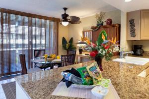 a kitchen with a sink and a counter top at Beachside Condo with Ocean Views in Kailua-Kona +38 photos