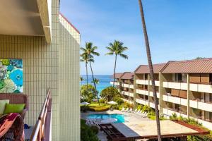 a view of the ocean from the balcony of a resort at Beachside Condo with Ocean Views in Kailua-Kona