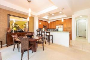 a kitchen and dining room with a table and chairs at Mauna Lani Fairways - Luxury Accommodations in Waikoloa