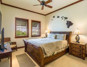 a bedroom with a bed and a ceiling fan at Kolea 14F - Heated Pool Gym & More in Waikoloa