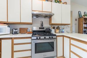a kitchen with a stove and a microwave at Elk Forest Escape - Economy Family Abode in South Lake Tahoe +31 photos