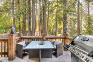 a deck with a grill and a table and chairs at Shining Shire - Sauna steam shower very cool in South Lake Tahoe +38 photos