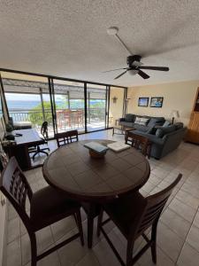 a living room with a table and a couch at Kona Alii - Oceanview Pool Shops & Restaurants in Kailua-Kona +18 photos