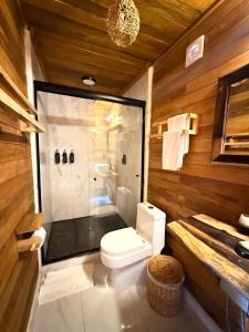 a bathroom with a shower and a toilet and a sink at Hotel Solana Bacalar Lakefront in Bacalar +119 photos