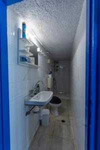 a bathroom with a sink and a toilet at Phone Booth in Koutsounari